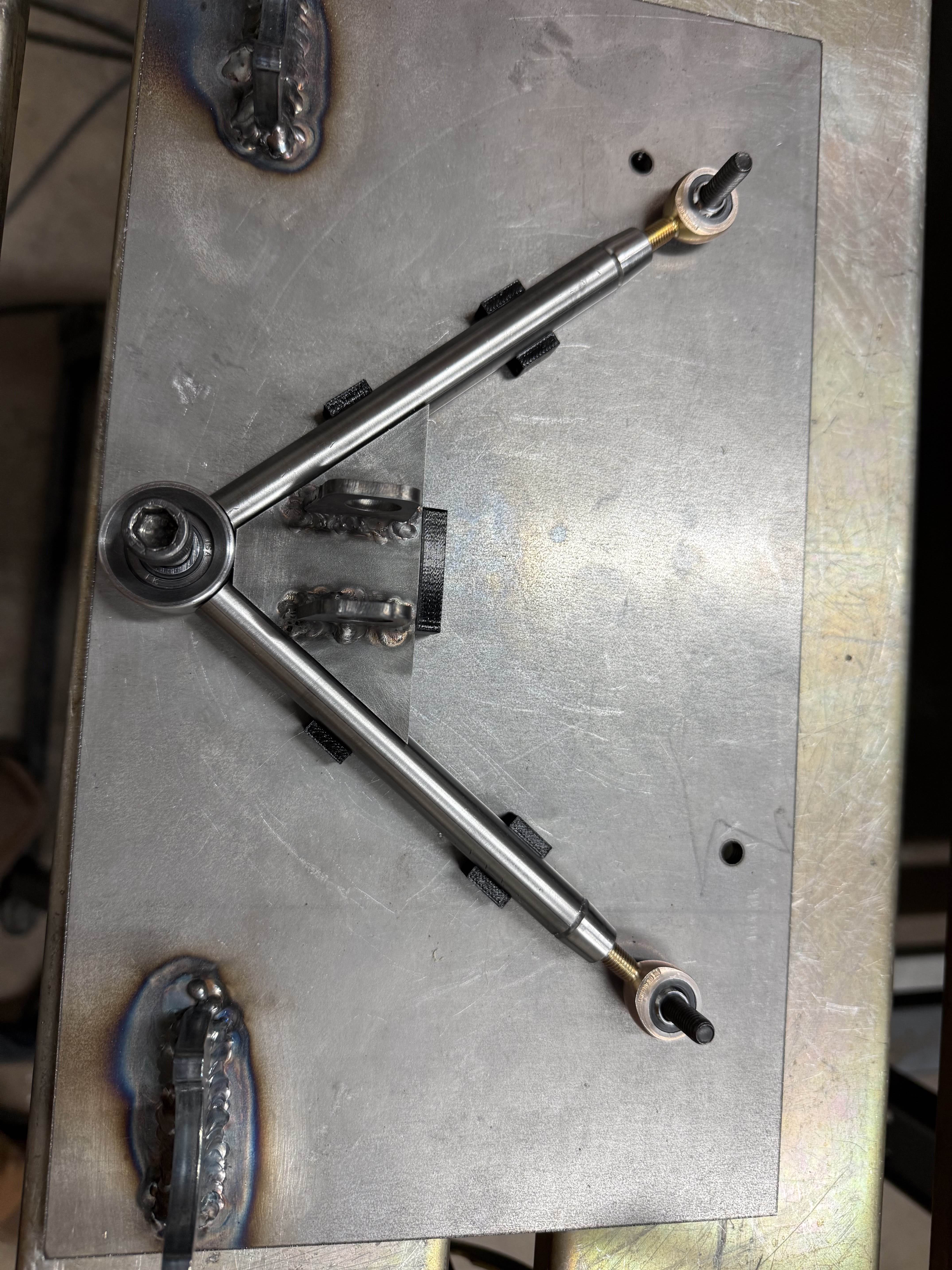 Control arm in the fixture plate designed to locate important mounting holes